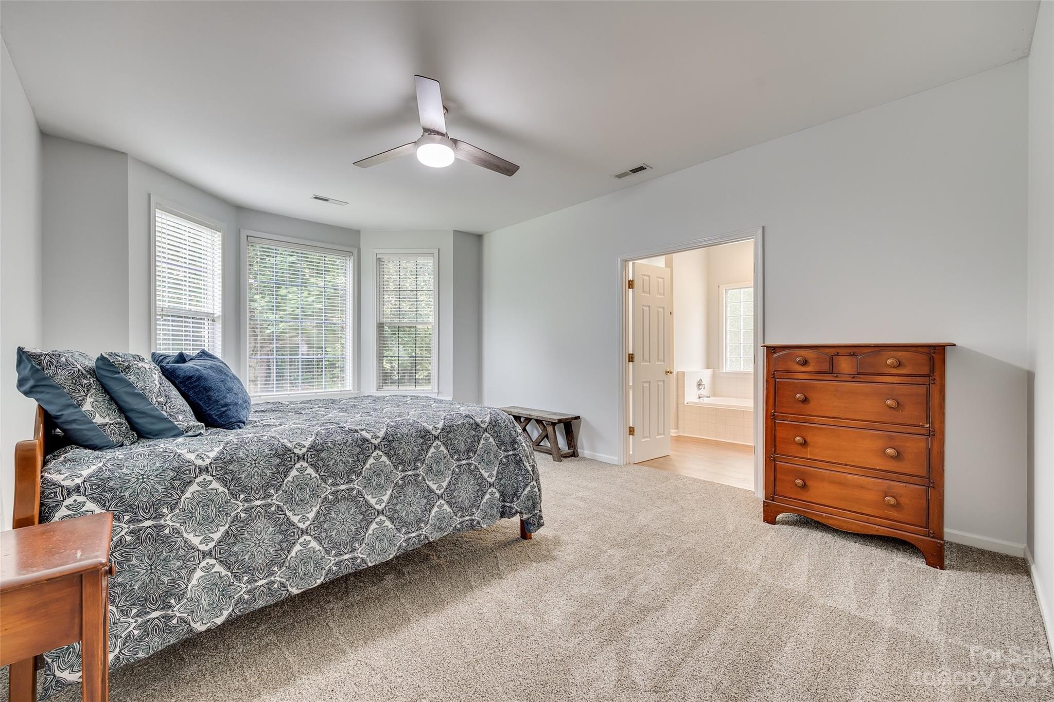 1028 Needles Drive Lancaster, SC 29720 - Photo 22 of 34 a spacious bedroom with a bed and cabinets