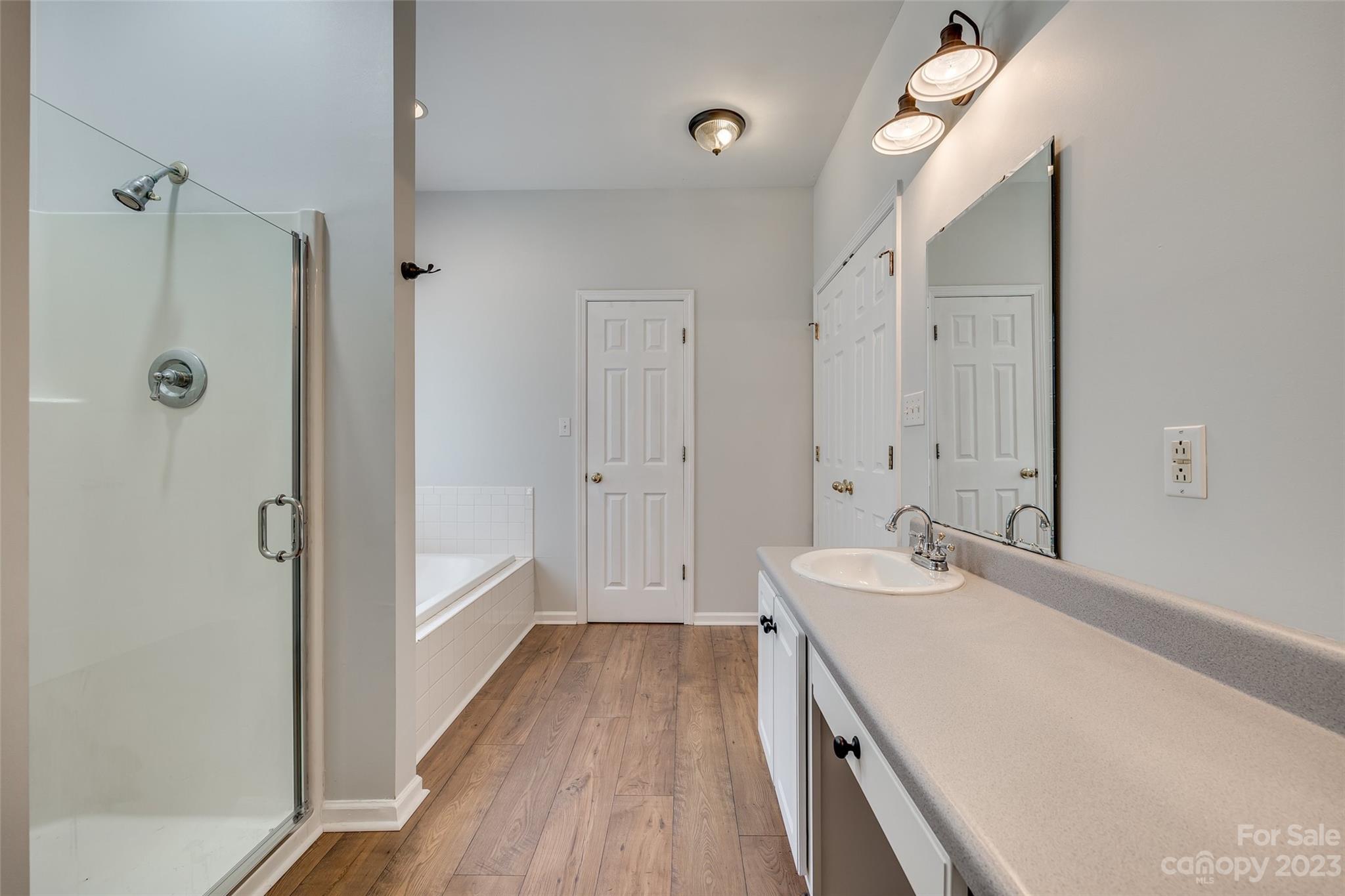1028 Needles Drive Lancaster, SC 29720 - Photo 26 of 34 a bathroom with a sink a mirror and a shower