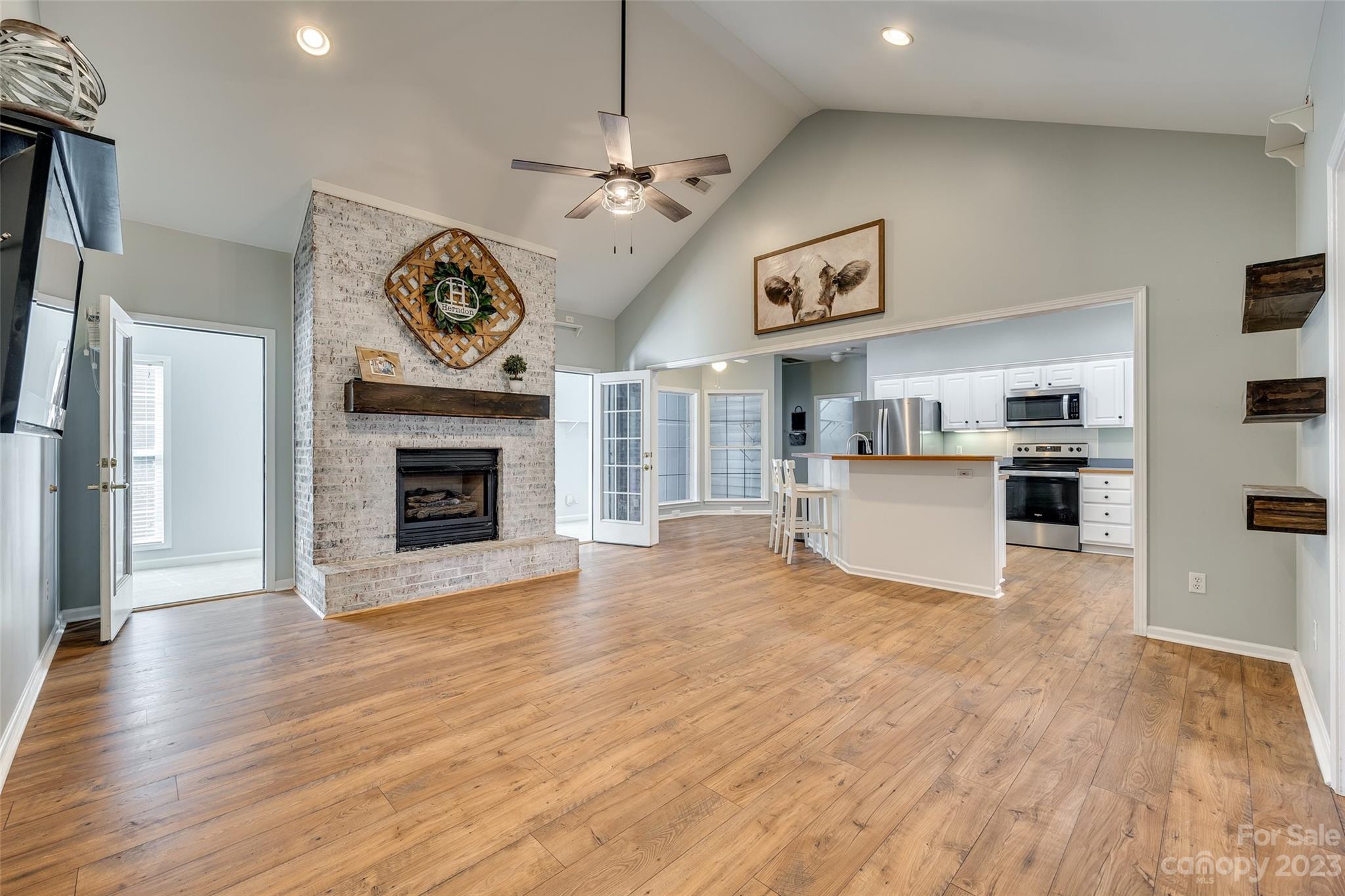 1028 Needles Drive Lancaster, SC 29720 - Photo 8 of 34 a view of a kitchen with a stove cabinets and wooden floor