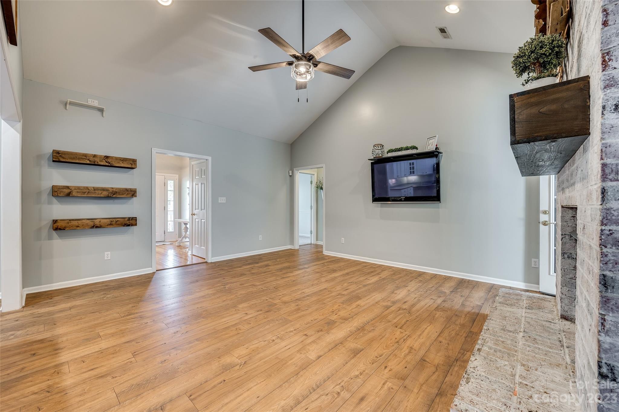 1028 Needles Drive Lancaster, SC 29720 - Photo 10 of 34 a view of an empty room with a ceiling fan and a window