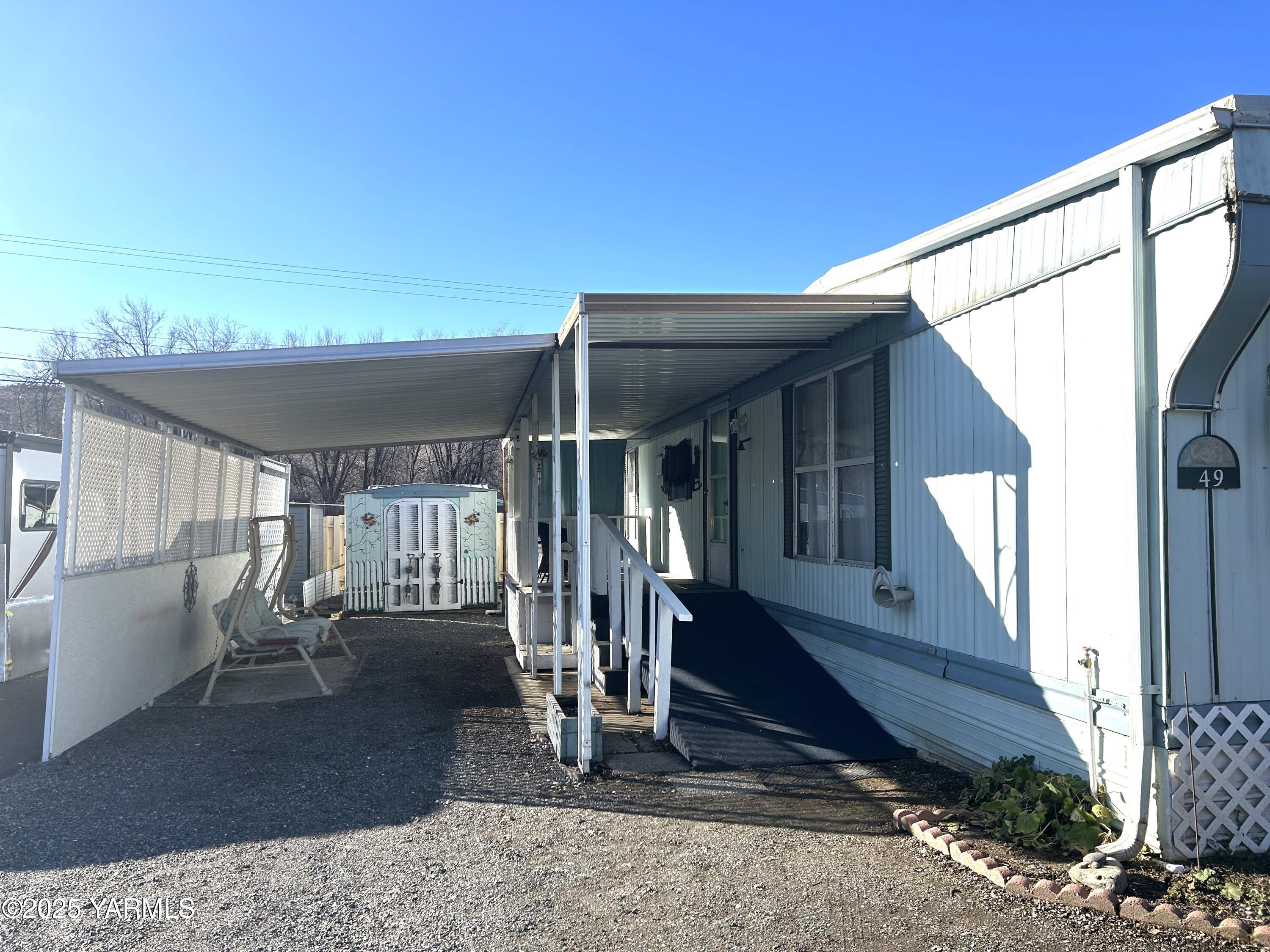 451 Pence Road, Unit 49 Yakima, WA 98908 - Photo 1 of 16 a view of a house with porch next to a yard