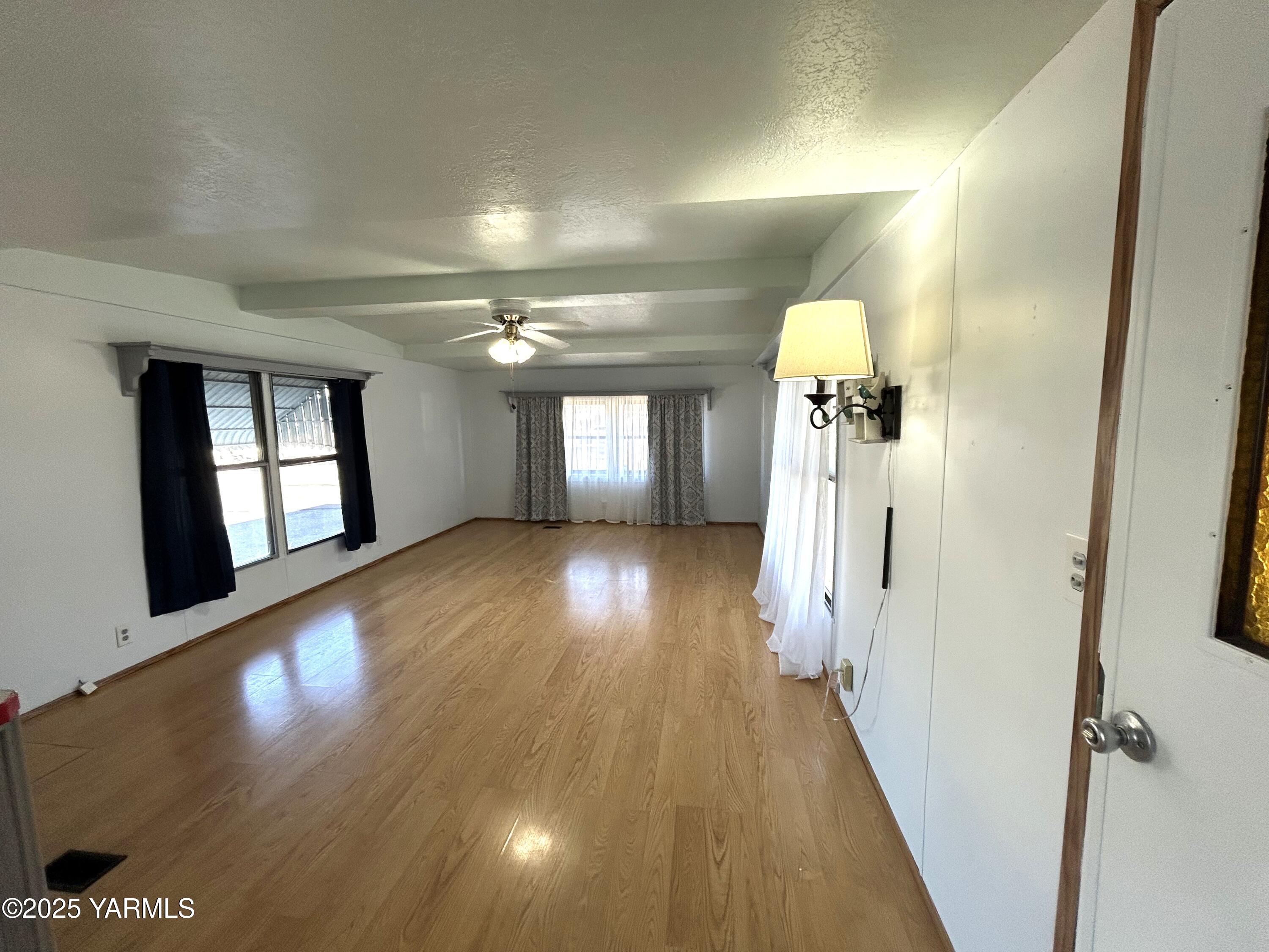 451 Pence Road, Unit 49 Yakima, WA 98908 - Photo 7 of 16 wooden floor in a hall with a mirror
