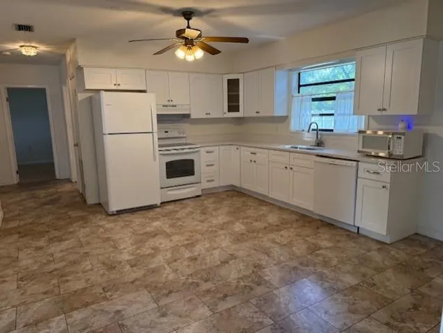 a kitchen with granite countertop cabinets stainless steel appliances and a counter space