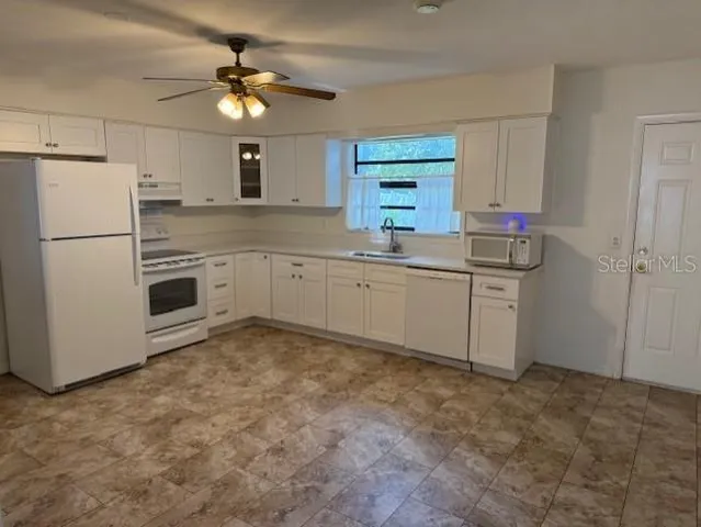 a kitchen with a sink stainless steel appliances and cabinets