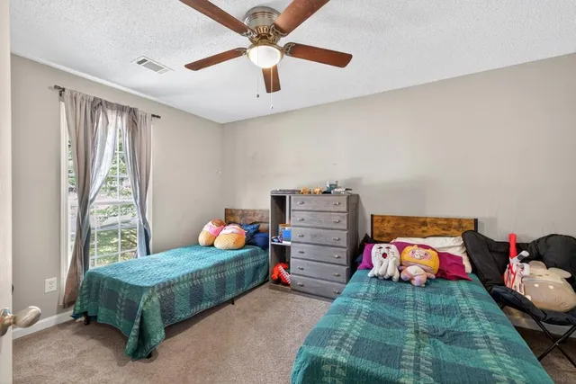 a bedroom with a bed and cabinets