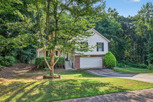 a view of a house with backyard and tree