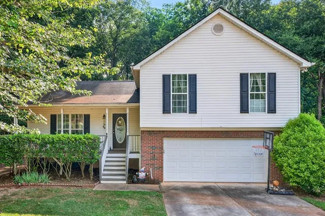 a front view of a house with a garden
