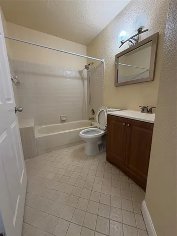 a bathroom with a toilet a sink and bathtub