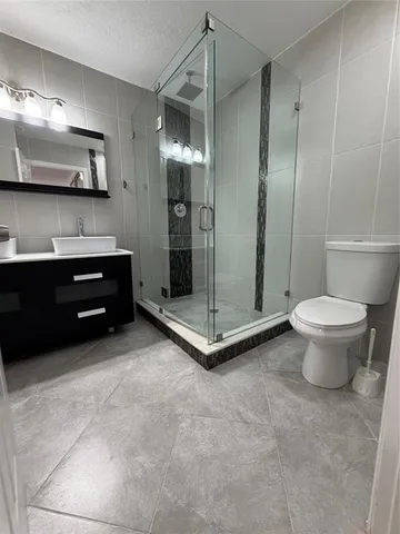 a spacious bathroom with a shower and a toilet