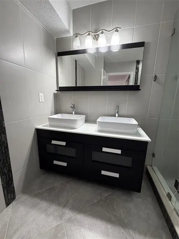 a room with a sink and a mirror