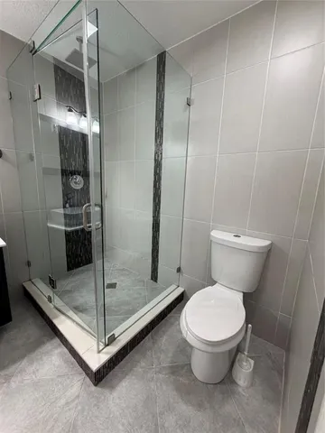 a white toilet sitting next to a bathroom sink