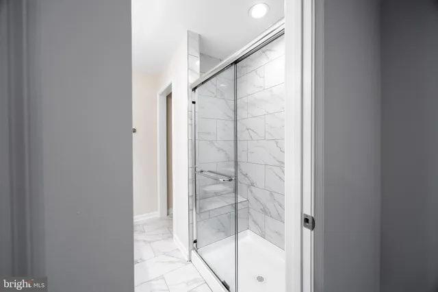 a bathroom with a glass shower door