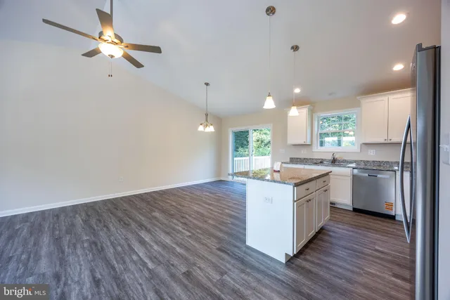 a kitchen with a sink hardwood floor and a window