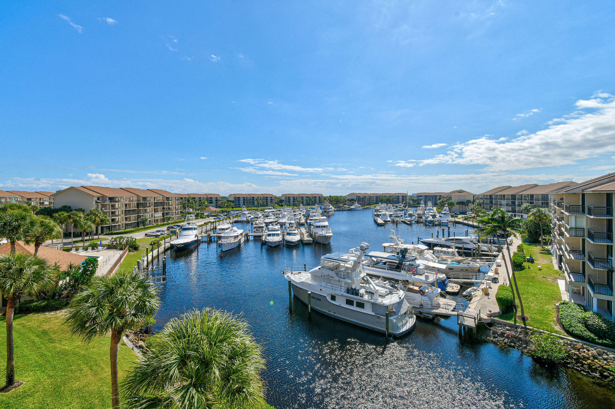 1601 Marina Isle Way, Unit 505 Jupiter, FL 33477 - Photo 1 of 23 a view of a lake with building in front of it