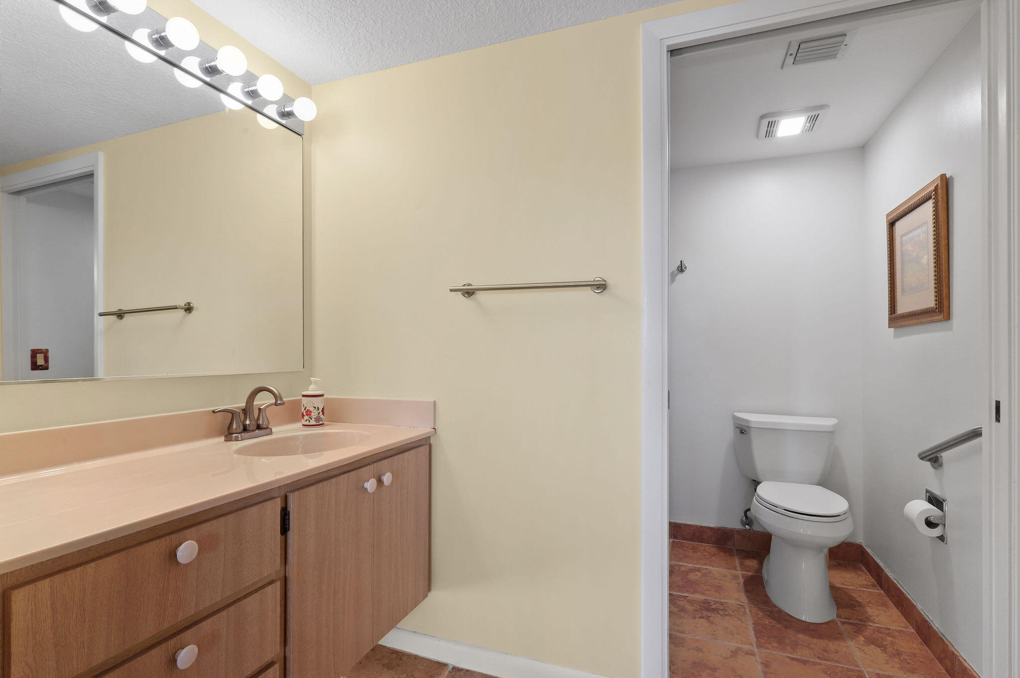 1601 Marina Isle Way, Unit 505 Jupiter, FL 33477 - Photo 11 of 23 a bathroom with a sink a toilet a mirror and shower