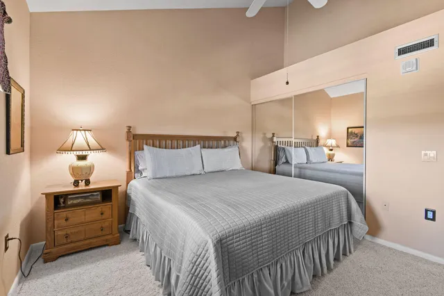 a bedroom with a bed and a night stand