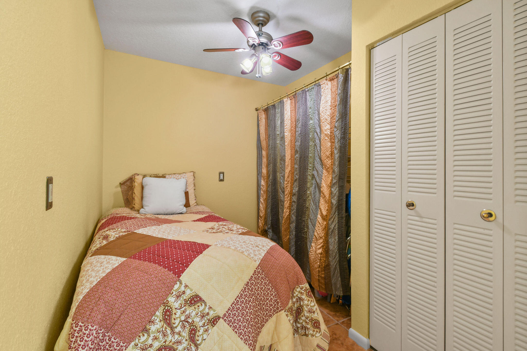 1601 Marina Isle Way, Unit 505 Jupiter, FL 33477 - Photo 17 of 23 a bedroom with a bed and a chandelier