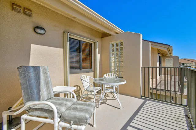 a view of a patio with table and chairs and wooden floor