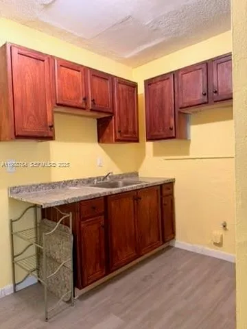 a kitchen with a sink and wooden cabinets