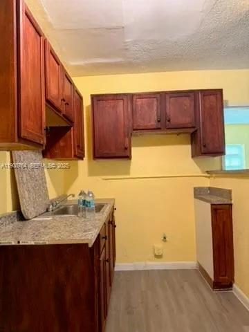 a kitchen with a sink a stove and a refrigerator