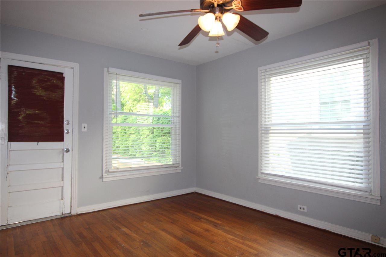 427 East 5th Street Tyler, TX 75701 - Photo 18 of 23 a view of an empty room with wooden floor and a window