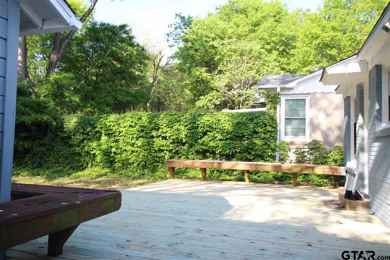 427 East 5th Street Tyler, TX 75701 - Photo 22 of 23 a view of backyard with potted plants and large tree