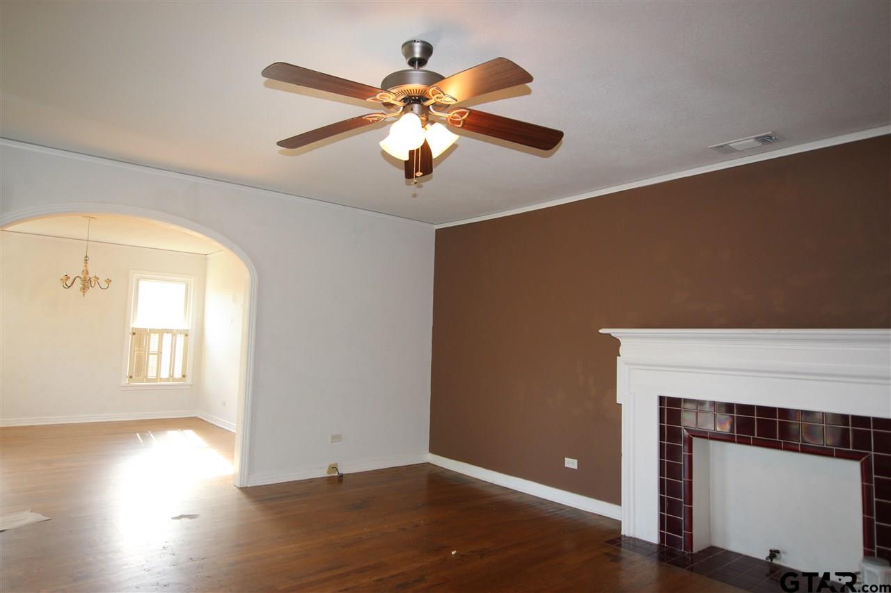 427 East 5th Street Tyler, TX 75701 - Photo 4 of 23 a view of an empty room with wooden floor and a window