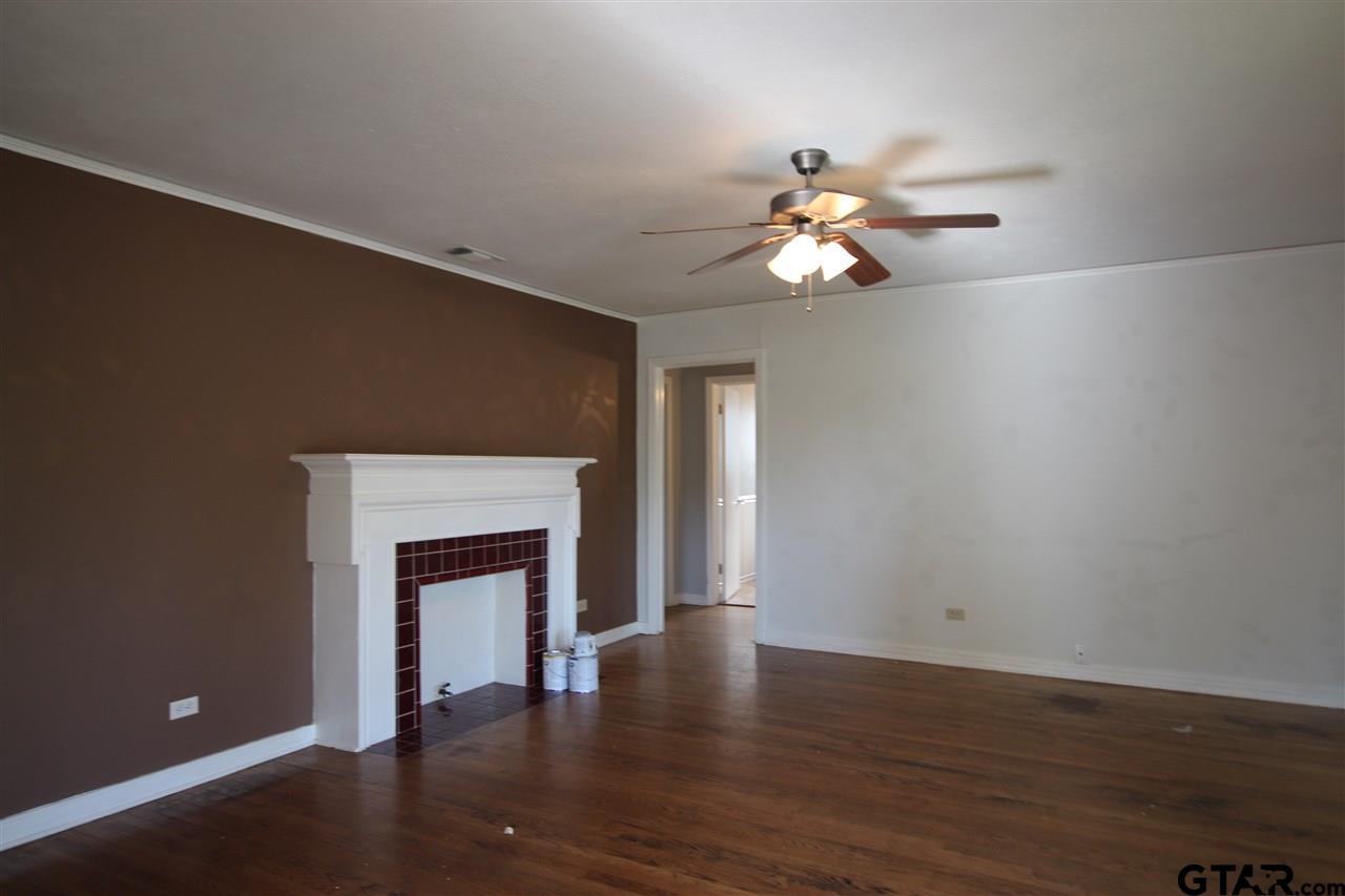 427 East 5th Street Tyler, TX 75701 - Photo 5 of 23 a view of an empty room with window and wooden floor