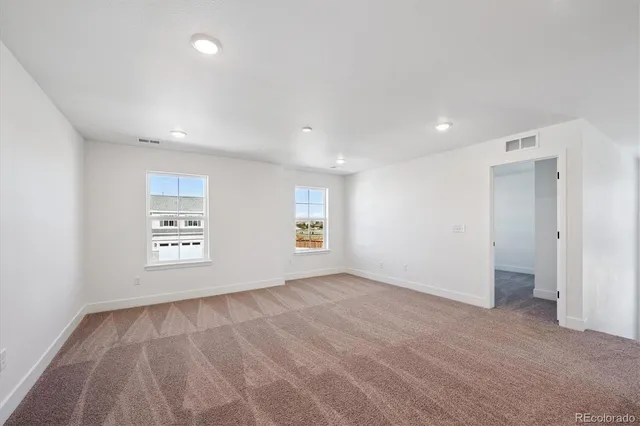 an empty room with a empty space and windows