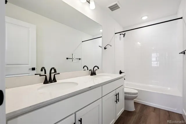a bathroom with a tub a sink and mirror