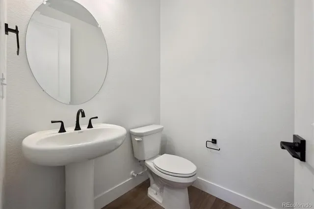 a bathroom with a sink a mirror and toilet