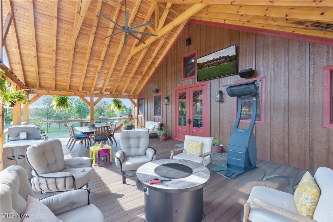 290 Townline Road Aurora, OH 44202 - Photo 29 of 50 Wooden terrace with a ceiling fan, an outdoor living space with a fire pit, outdoor dining space, area for grilling, and french doors