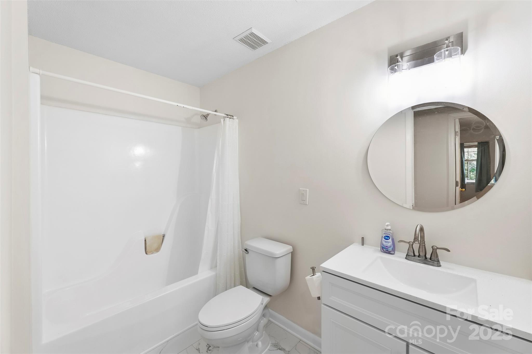 2836 Huntingtowne Farms Lane Charlotte, NC 28210 - Photo 11 of 38 a bathroom with a sink a toilet and a mirror