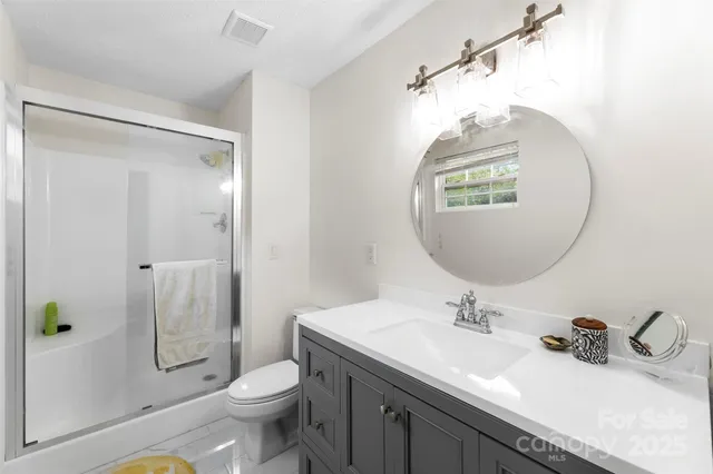 a bathroom with a sink toilet and shower