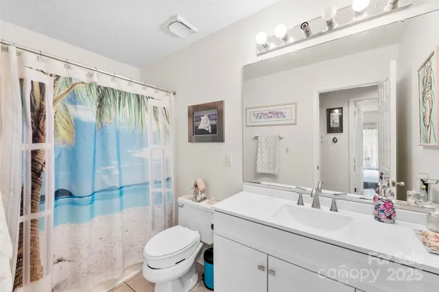 a bathroom with a sink vanity mirror and toilet