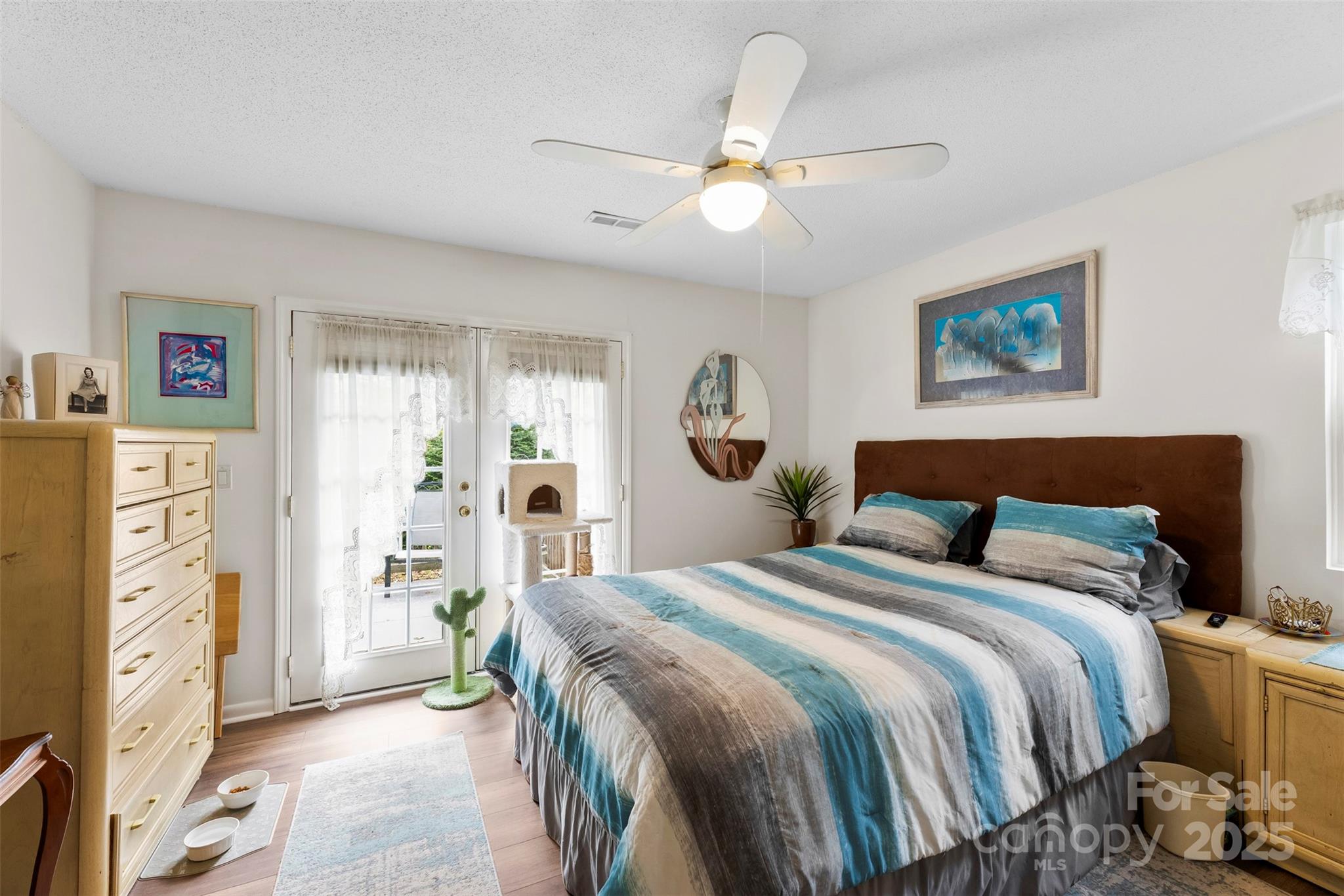 2836 Huntingtowne Farms Lane Charlotte, NC 28210 - Photo 22 of 38 a spacious bedroom with a bed and a chandelier