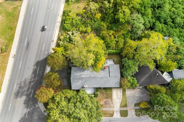 an aerial view of a house with a yard and garden