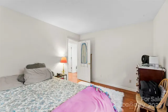 a bedroom with a bed and a mirror