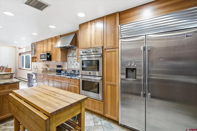 a kitchen with a refrigerator and a sink