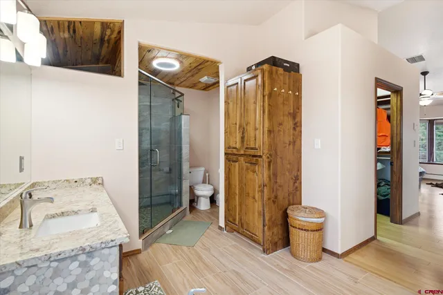 a spacious bathroom with a sink a toilet and shower