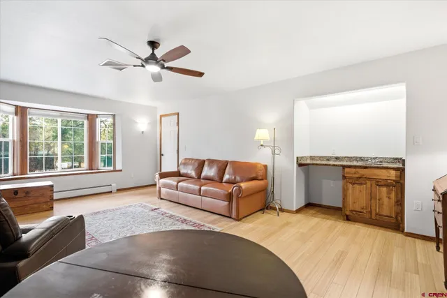 a living room with furniture and a large window