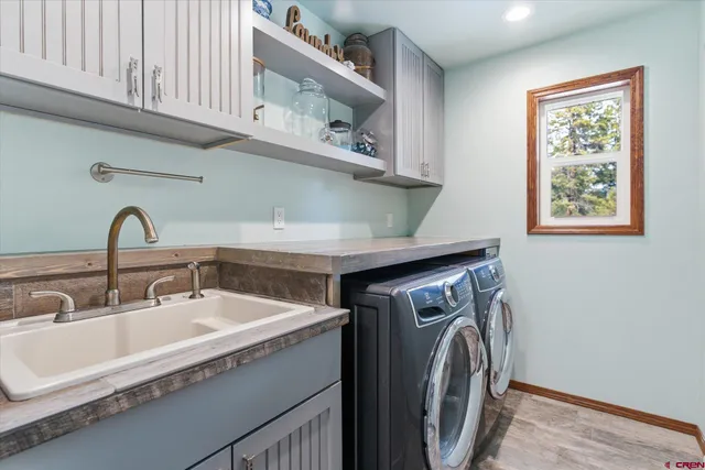 a utility room with stainless steel appliances washer and dryer