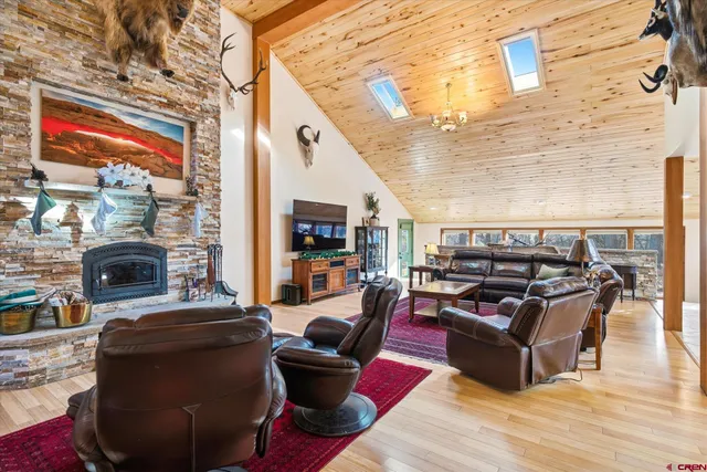 a living room with furniture a fireplace and city view