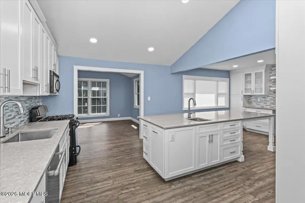 a kitchen with a sink stove and cabinets