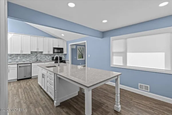 a kitchen with a stove a sink and a refrigerator
