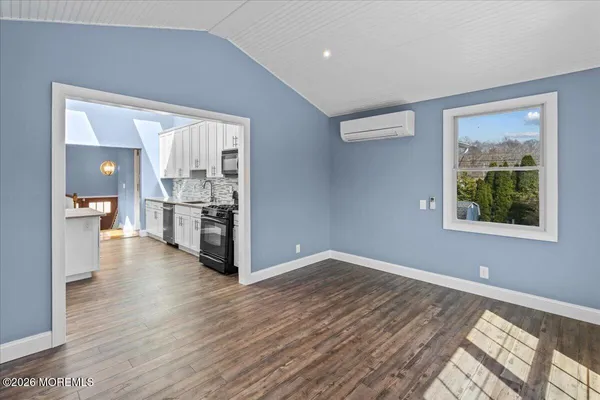 a view of a kitchen with wooden floor and a kitchen
