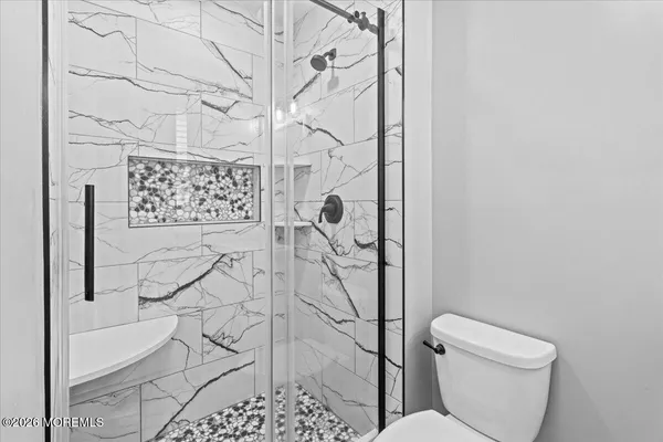 a bathroom with a toilet and shower