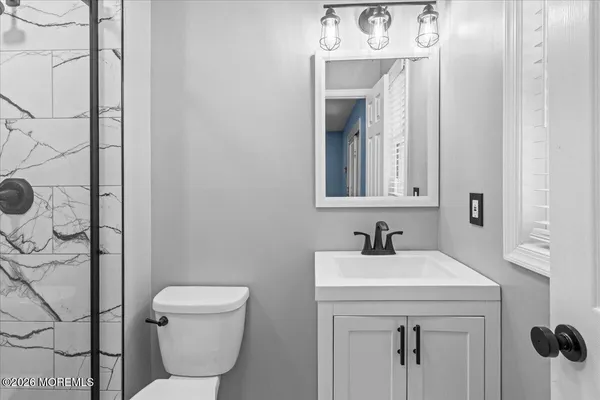 a bathroom with a toilet sink and mirror