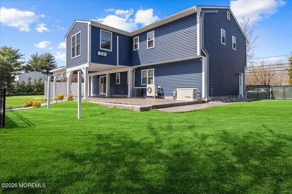 a view of a house with a yard and sitting area