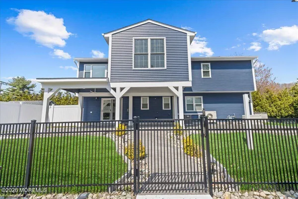 a front view of a house with a iron fence